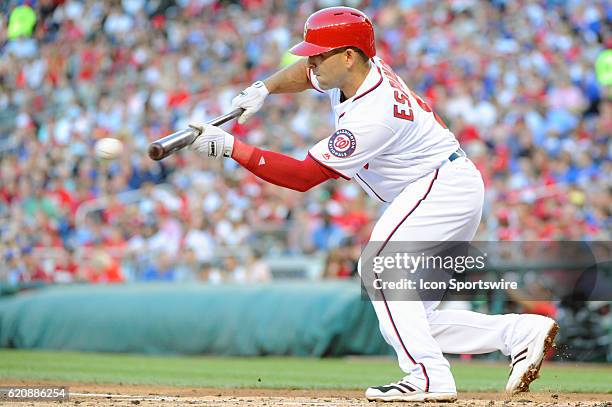 Washington Nationals shortstop Danny Espinosa bunts for a single against the Chicago Cubs at Nationals Park in Washington, D.C. Where the Chicago...