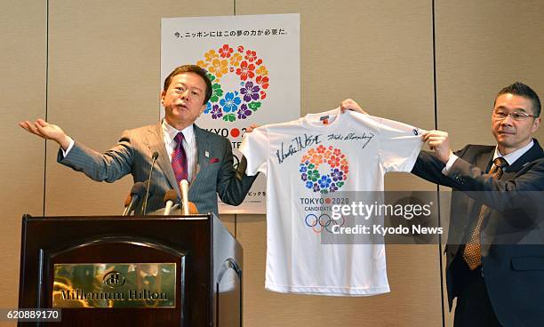 United States - Tokyo Gov. Naoki Inose holds a T-shirt to promote Tokyo's 2020 Summer Olympics bid during a press conference in New York on April 16,...