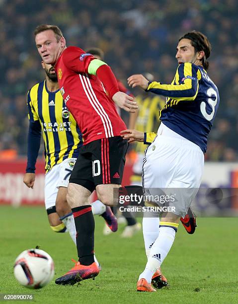 Manchester United's Wayne Rooney vies with Fenerbahce's Hasan Ali Kaldirim during the UEFA Europa League football Fenerbahce SK vs Manchester United...