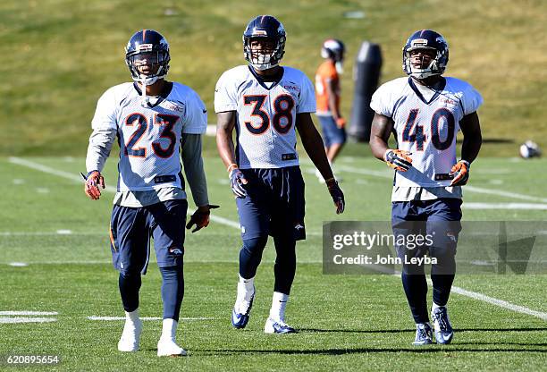 Denver Broncos running back Devontae Booker Denver Broncos running back Terrell Watson and Denver Broncos Juwan Thompson head to drills during...