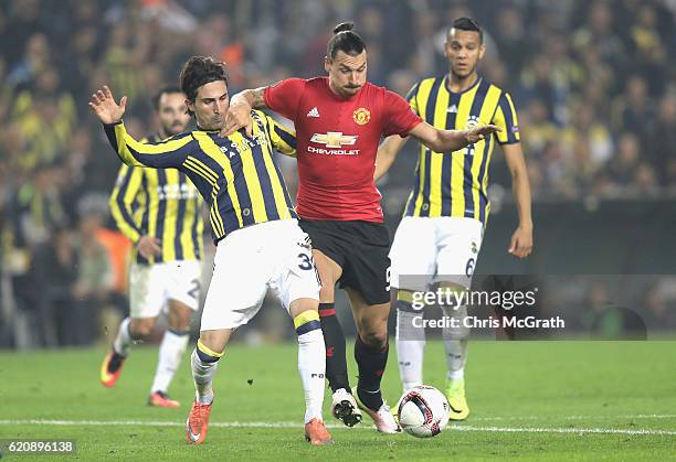 Zlatan Ibrahimovic of Manchester United holds of a tackle from Hasan Ali Kaldirim of Fenerbahce during the UEFA Europa League Group A match between...