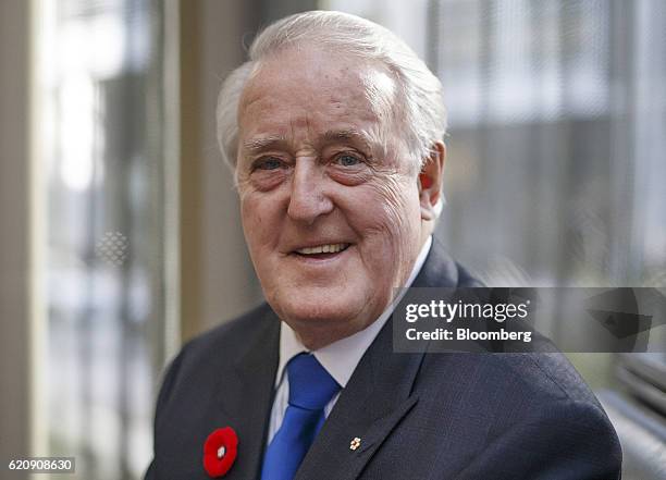 Brian Mulroney, Canada's former prime minister, sits for a photograph before introducing George Mitchell, a former Senator from Maine, not pictured,...