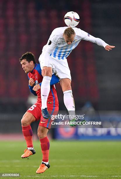 Steaua's Romanian midfielder Alexandru Bourceanu and Zurich's Slovene forward Dzengis Cavusevic vie for the ball during the UEFA Europa League Group...