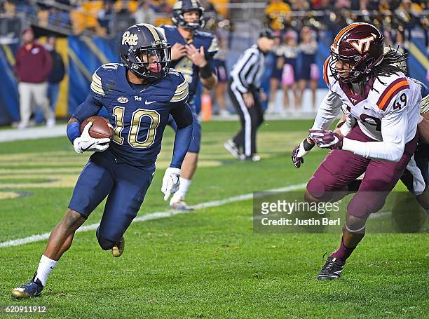 Quadree Henderson of the Pittsburgh Panthers rushes against Tremaine Edmunds of the Virginia Tech Hokies in the first half during the game at Heinz...