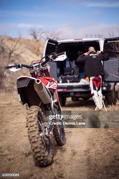 close up of motorcycle behind dirt bike rider and van - glen haven co stock pictures, royalty-free photos & images