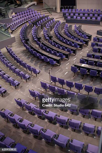high angle view of empty chairs in german parliament hall - regierung stock-fotos und bilder