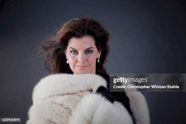 caucasian woman wearing fur coat - woman in fur coat stock-fotos und bilder