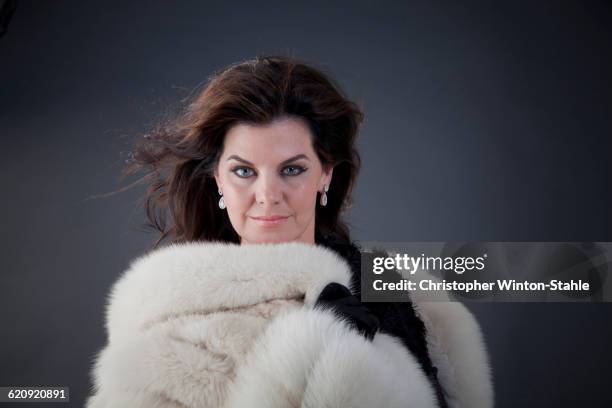 caucasian woman wearing fur coat - fur coat stock pictures, royalty-free photos & images