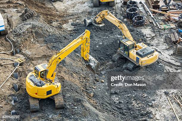 aerial view of diggers at construction site - construction equipment stock pictures, royalty-free photos & images