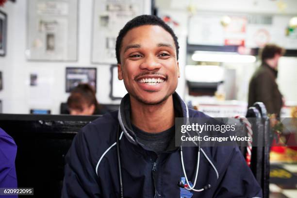 paramedic smiling in restaurant - paramedic portrait stock pictures, royalty-free photos & images