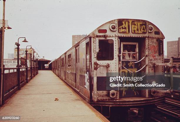 Subway car marked with extensive graffiti waits at a station platform, New York City, New York, 1972. Image courtesy National Archives. .
