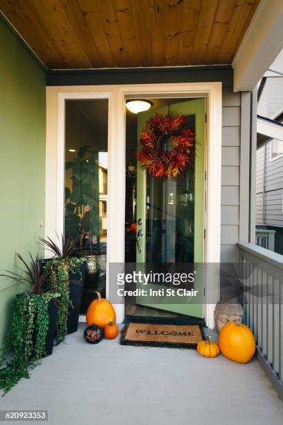 pumpkins and wreath in doorway - autumn wreath stock pictures, royalty-free photos & images