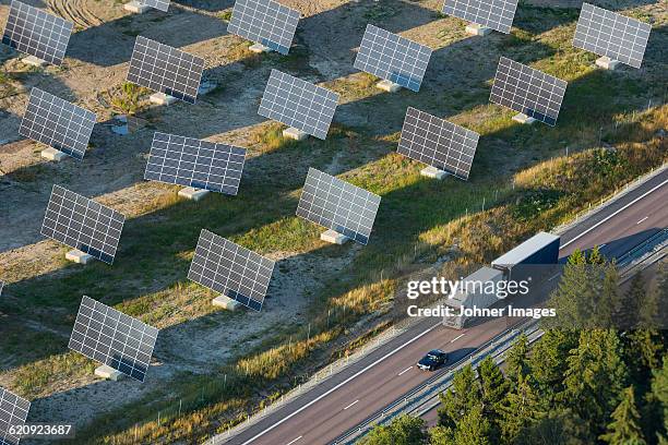 solar farm near road - tilt shift technik stock-fotos und bilder