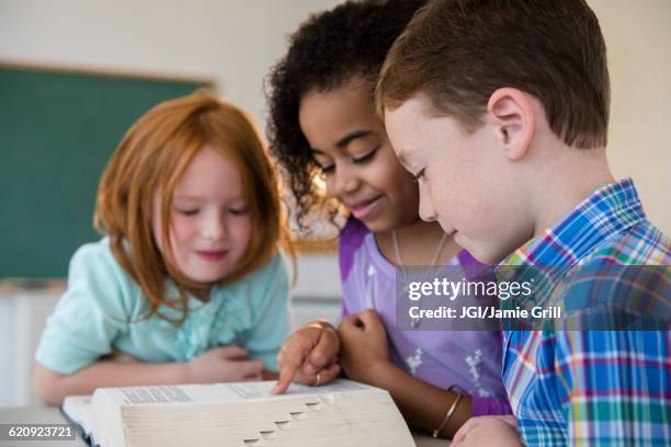 students using dictionary in classroom - vocabulary stock pictures, royalty-free photos & images