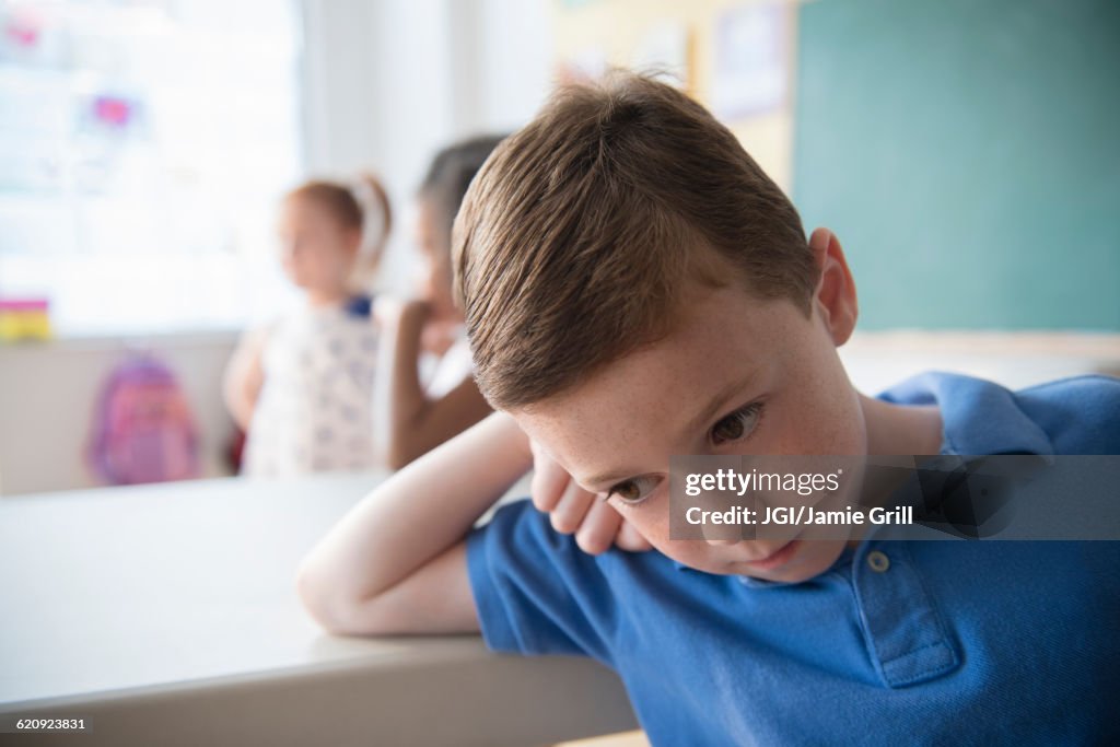 Sad student leaning on desk