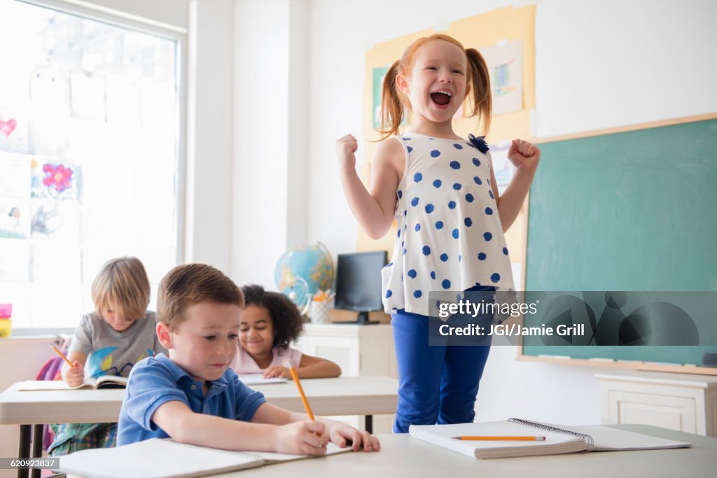 Student shouting at desk in classroom