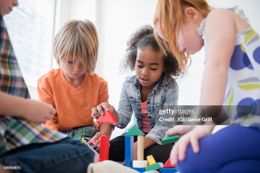 Children playing with blocks on floor