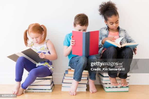 barefoot students reading books - children only diversity stock pictures, royalty-free photos & images