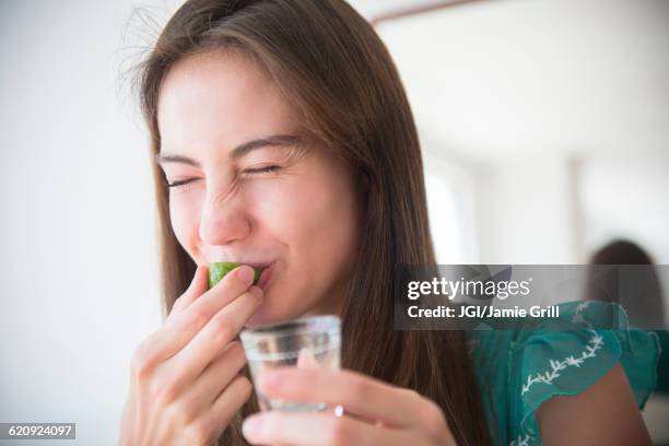 native american woman drinking tequila shot - tequila drink stock pictures, royalty-free photos & images