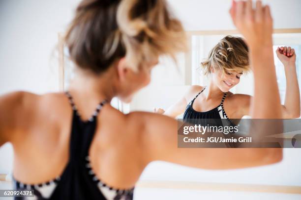 mixed race dancer practicing in studio - woman mirror stock pictures, royalty-free photos & images