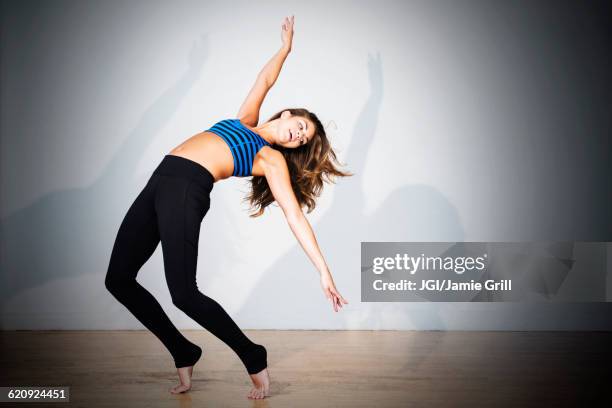 mixed race dancer practicing in studio - danza moderna foto e immagini stock