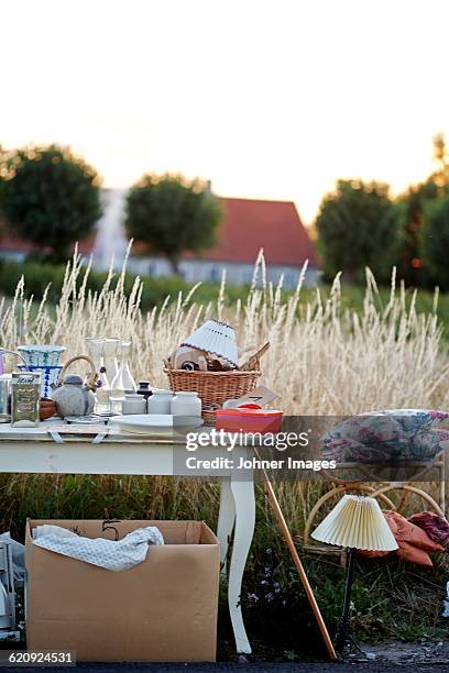 chair and table in field - rommelmarkt stockfoto's en -beelden