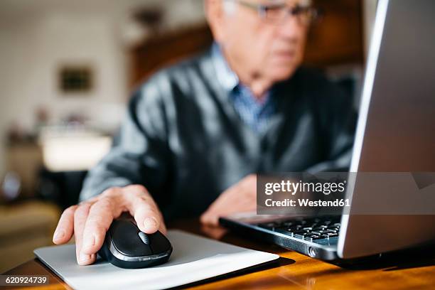 hand of senior man using mouse, close-up - senior men computer stock pictures, royalty-free photos & images