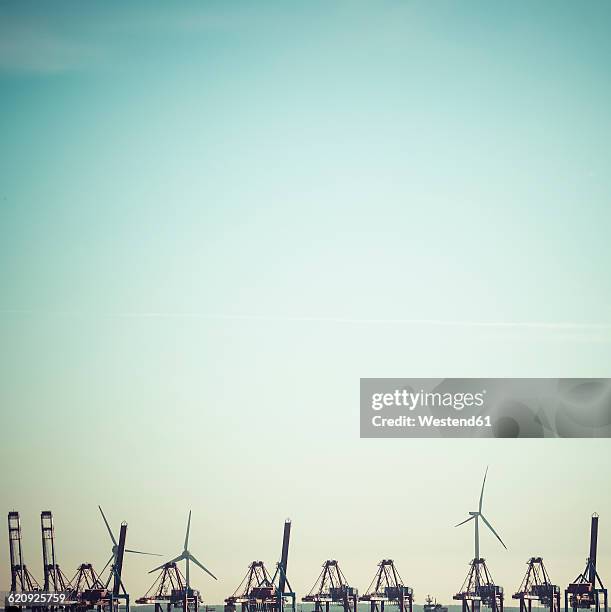 germany, hamburg, harbour, cranes and wind wheels, copy space - hamburger hafen stock-fotos und bilder