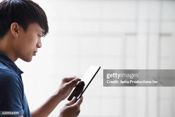 vietnamese businessman using digital tablet - ipad close up stock pictures, royalty-free photos & images