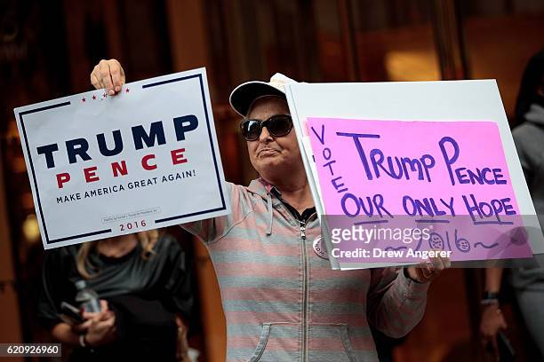 Supporter of Republican presidential candidate Donald Trump stands outside of Trump Tower, November 3, 2016 in New York City. Election Day is less...