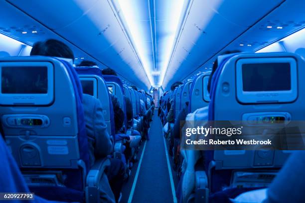 aisle in full airplane - aisle seat airline stock-fotos und bilder