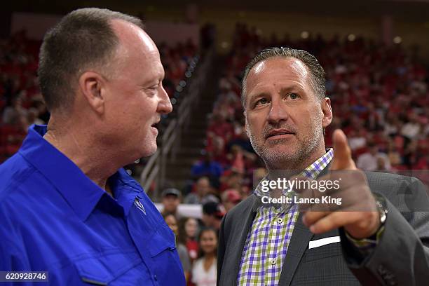 Head coach Mark Gottfried of the North Carolina State Wolfpack talks with head coach Jeff Price of the Lynn Fighting Knights prior to their game at...