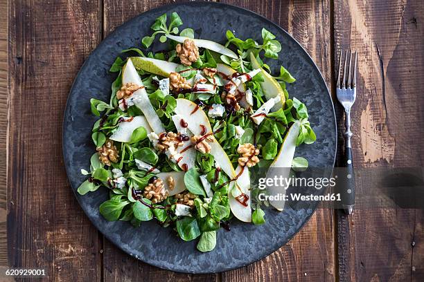 lamb's lettuce with pear, gorgonzola and walnut on plate, fork - poire photos et images de collection