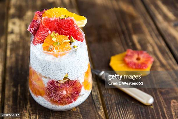 chia pudding and slices of orange blood orange and grapefruit in glass - blood orange stock pictures, royalty-free photos & images