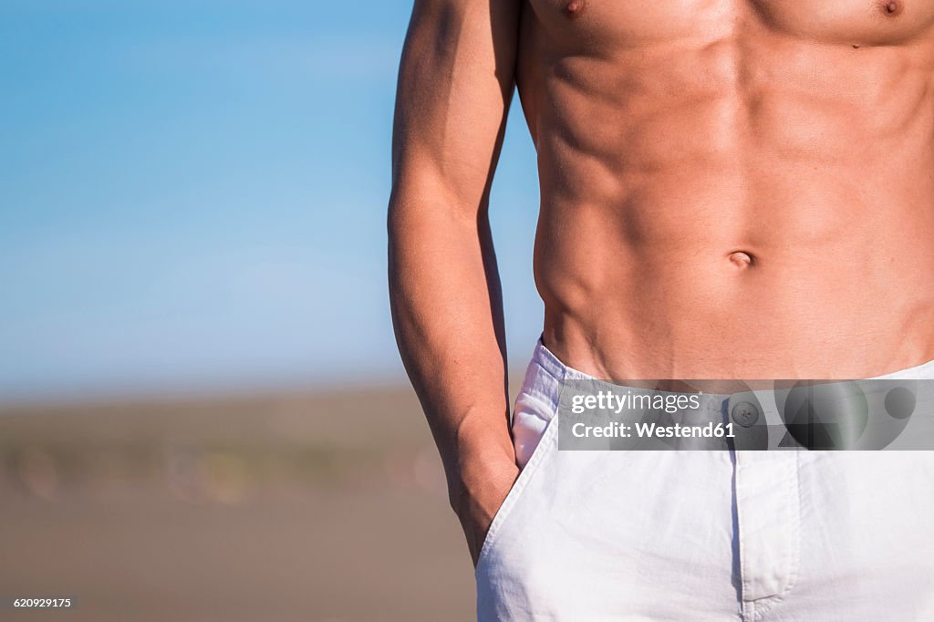 Spain, Tenerife, close-up of man standing on the beach
