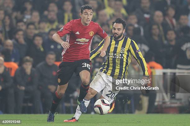 Matteo Darmian of Manchester United runs with the ball under pressure from Volkan Sen of Fenerbahce during the UEFA Europa League Group A match...