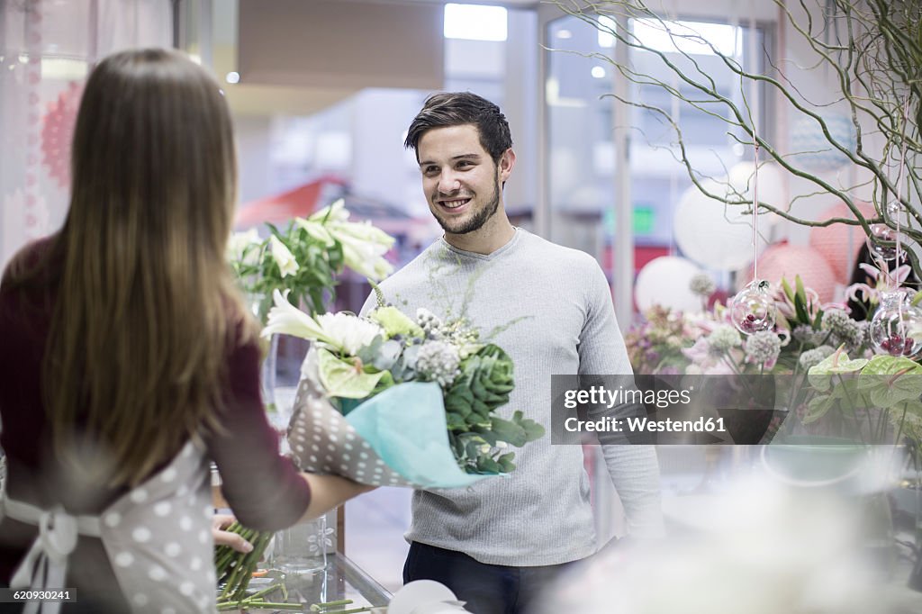 Man buying flowers in flower shop