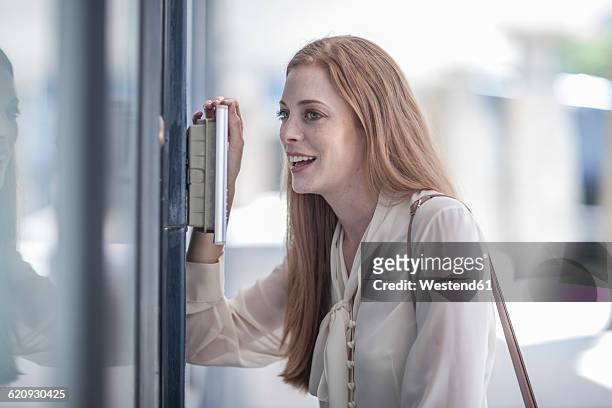young businesswoman talking at intercom - buzzer stock-fotos und bilder