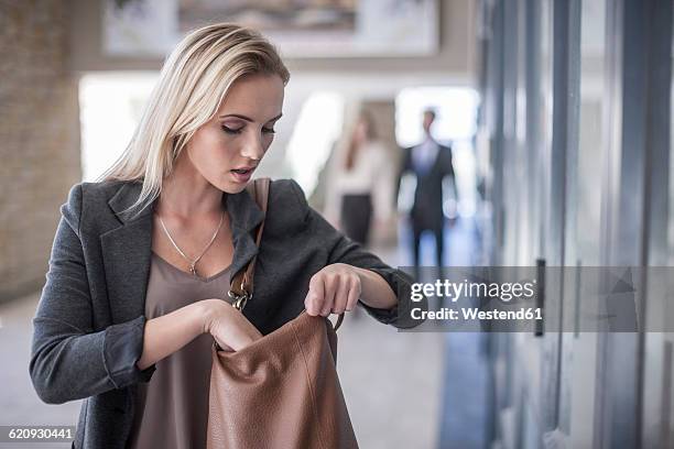 young businesswoman - looking in bag stock-fotos und bilder