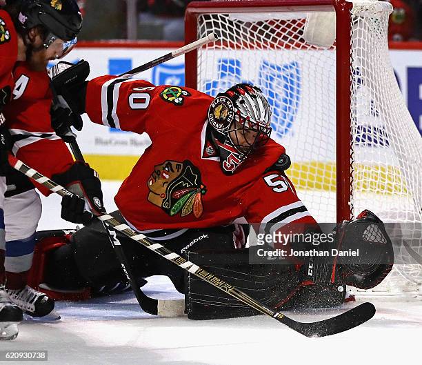 Corey Crawford of the Chicago Blackhawks stops a shot with his shoulder against the Colorado Avalanche at the United Center on November 3, 2016 in...