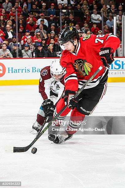 Artemi Panarin of the Chicago Blackhawks and Matt Duchene of the Colorado Avalanche chase the puck in the second period at the United Center on...