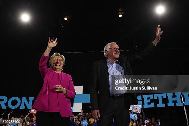 Democratic presidential nominee Hillary Clinton and U.S. Sen Bernie Sanders greet supporters during a campaign rally at Coastal Credit Union Music...