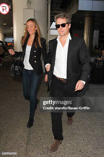 Hugh Grant and Anna Elisabet Eberstein are seen at LAX on November 03, 2016 in Los Angeles, California.