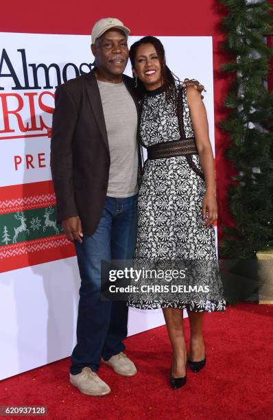 Danny Glover and wife Eliane Cavalleiro attend the premiere of Almost Christmas at the Regency Village theatre in Westwood, California on November 3,...