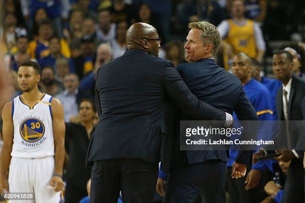 Head coach Steve Kerr of the Golden State Warriors is held back by assistant coach Mike Brown after Kerr received a Technical Foul in the game...