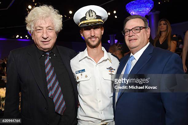 Producer Avi Lerner and lawyer Marty Singer pose with Israeli Defense soldier during the Friends Of The Israel Defense Forces Western Region Gala at...