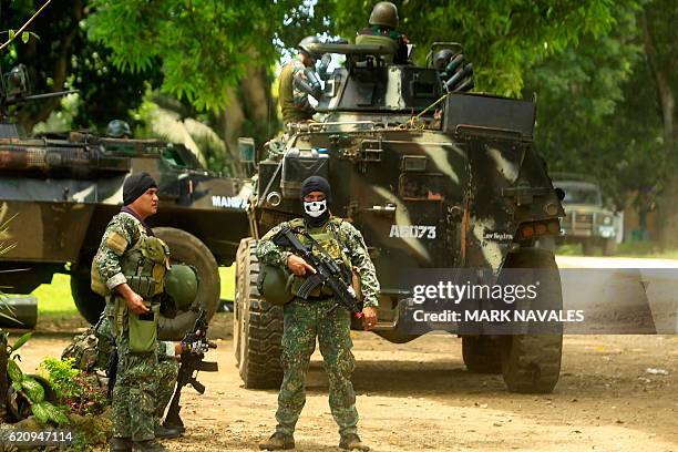 This photo taken on September 5, 2016 shows Philippine soldiers standing guard next to an Armored Personnel Carrier inside a military camp in Jolo,...