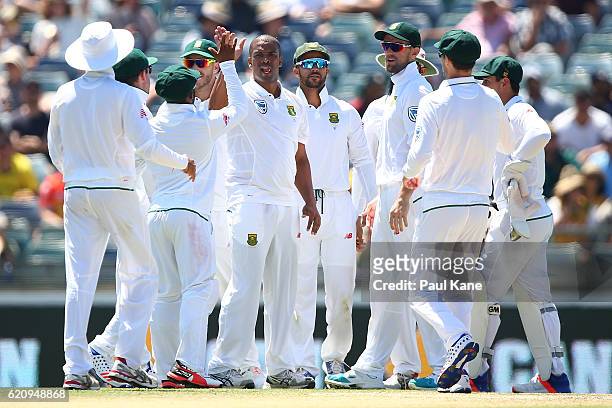 Vernon Philander of South Africa celebraes with team mates after dimissing Mitch Marsh of Australia during day two of the First Test match between...