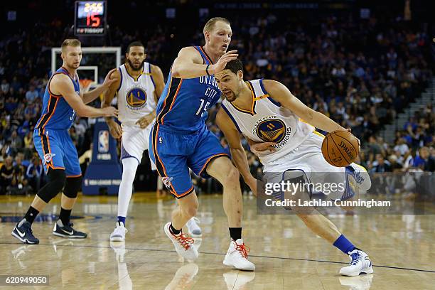 Klay Thompson of the Golden State Warriors drives past Kyle Singler of the Oklahoma City Thunder at ORACLE Arena on November 3, 2016 in Oakland,...