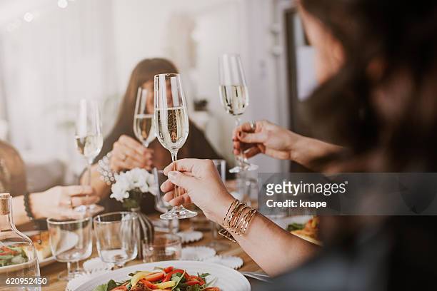mature women having dinner party - champagne stock pictures, royalty-free photos & images